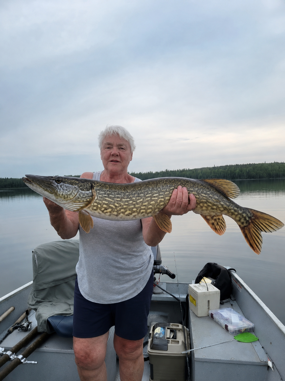Jackie holding a northern pike on a Minnesota lake