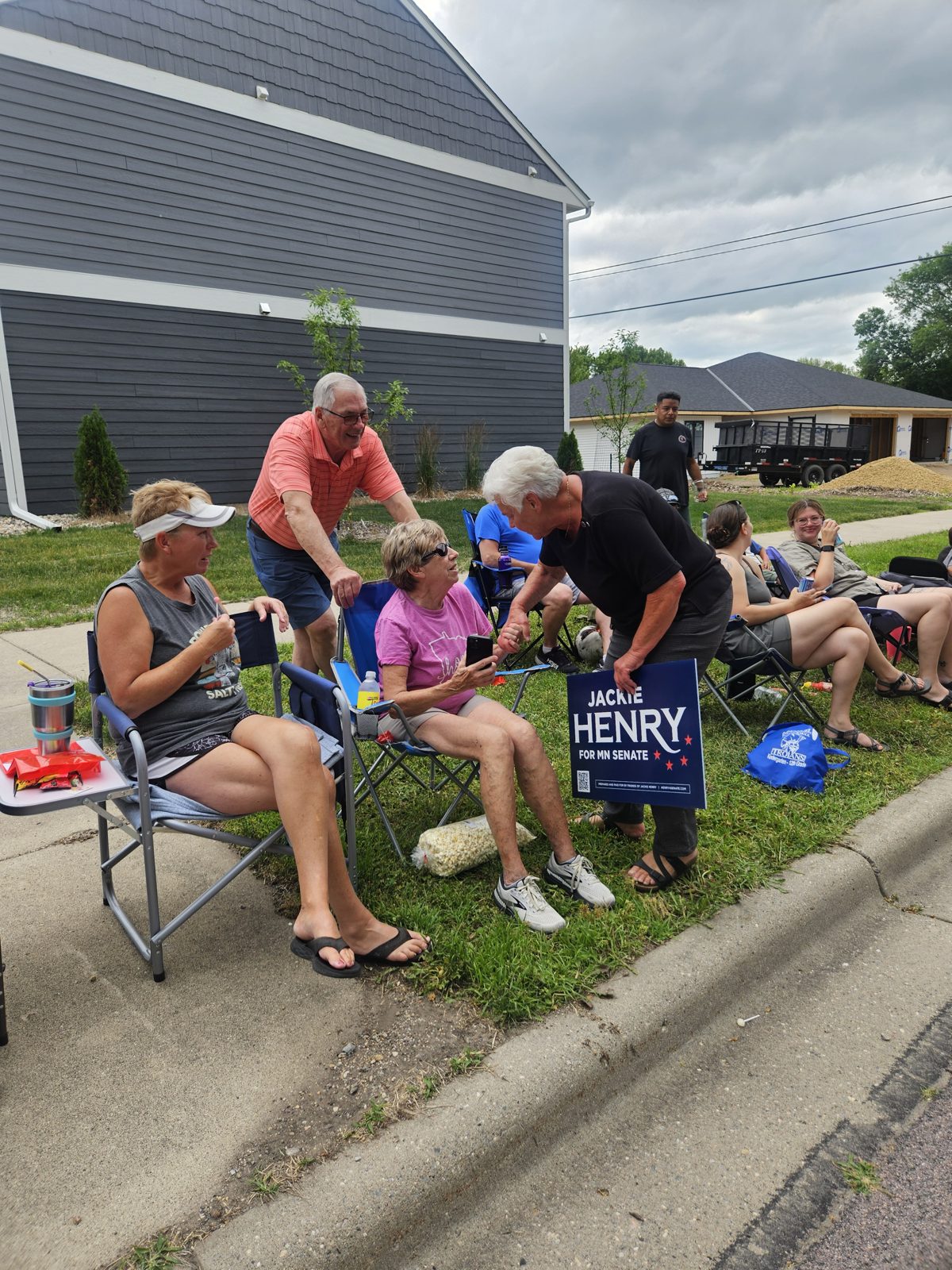 Supporters gathered around a Jackie Henry for Senate yard sign in Nicollet